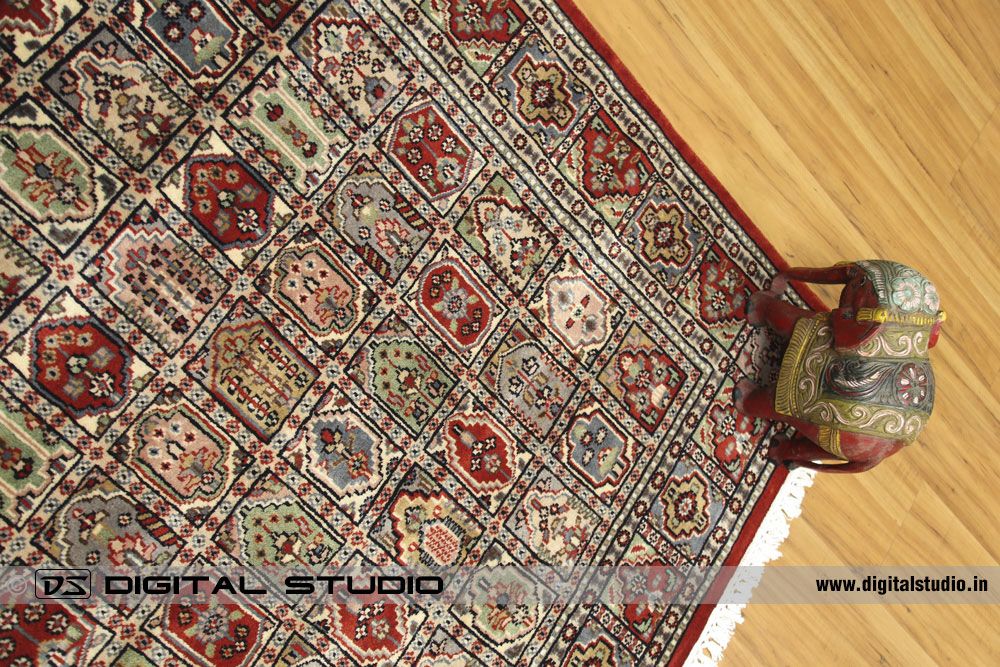 Top view of oriental hand made carpet with red elephant prop