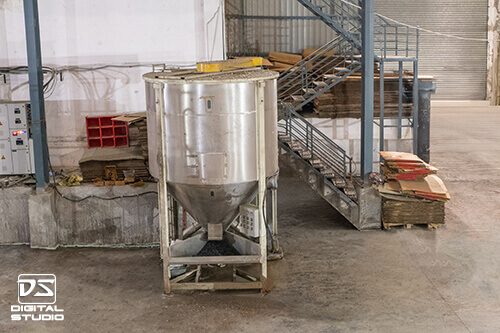Industrial equipment photography of stainless steel hopper mixer in a manufacturing unit
