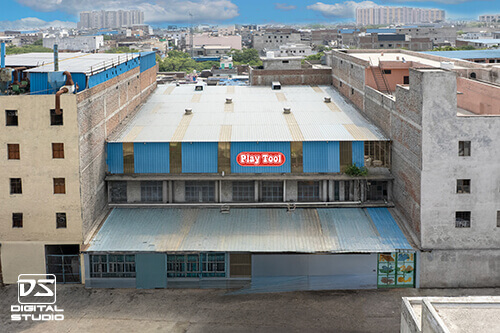 Rooftop drone shot showing factory branding and industrial building layout