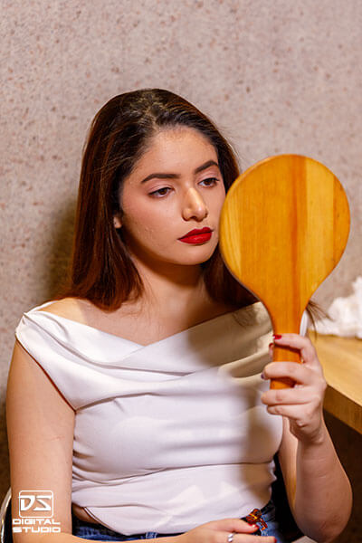 Female model preparing for a commercial perfume photography and video shoot at Digital Studio.