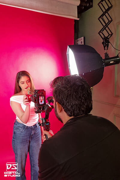 Behind-the-scenes perfume video shoot with model and gimbal camera setup at Digital Studio Mumbai.
